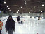 At Wayn Gretzky Arena, Pat walks past Les Sutch while Tina and Murray have a discussion near Murray's Catrike Speed, Joe at center ice doing his organising.